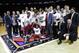 Stanford coach Johnny Dawkins, with red tie, poses for photographs with his team and the tournament trophy after the championship game against Miami at the NIT college basketball tournament Thursday, April 2, 2015, in New York. Stanford won 66-64 in overtime. (AP Photo/Frank Franklin II)