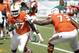 Miami defensive lineman Ufomba Kamalu (47) and offensive lineman Trevor Darling (73) run through drills before the start of an NCAA college football game against Nebraska, Saturday, Sept. 19, 2015 in Miami Gardens, Fla. (AP Photo/Wilfredo Lee)