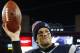 FILE - In this Jan. 10, 2015, file photo, New England Patriots quarterback Tom Brady holds up the game ball after an NFL divisional playoff football game against the Baltimore Ravens in Foxborough, Mass. Brady was able suit up for his team's season opener after a judge erased his four-game suspension for