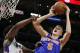 New York Knicks forward Kristaps Porzingis, left, of Latvia, shoots against Los Angeles Clippers center DeAndre Jordan, right, during the second half of an NBA basketball game in Los Angeles, Friday, March 11, 2016. The Clippers won 101-94. (AP Photo/Alex Gallardo)