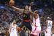 Mar 10, 2016; Toronto, Ontario, CAN; Atlanta Hawks guard Kent Bazemore (24) is fouled by Toronto Raptors center Bismack Biyombo (8) at Air Canada Centre. The Raptors beat the Hawks 104-96. Mandatory Credit: Tom Szczerbowski-USA TODAY Sports
