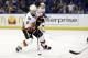 Calgary Flames' Dennis Wideman controls the puck during the third period of an NHL hockey game against the St. Louis Blues Thursday, April 2, 2015, in St. Louis. The Blues won 4-1. (AP Photo/Jeff Roberson)