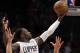 Los Angeles Clippers forward Jeff Green (8) goes up against Denver Nuggets center Joffrey Lauvergne (77) and guard D.J. Augustin (12) during the second half of an NBA basketball game in Los Angeles, Wednesday, Feb. 24, 2016. The Nuggets won 87-81. (AP Photo/Alex Gallardo)
