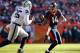 Denver Broncos wide receiver Cody Latimer (14) bobbles his catch as Oakland Raiders defensive end Benson Mayowa (95) pursues during the first half of an NFL football game, Sunday, Dec. 13, 2015, in Denver. (AP Photo/Jack Dempsey)