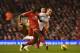 Liverpool's French defender Mamadou Sakho (L) plays the ball under pressure from Tottenham Hotspur's English striker Harry Kane (R) during the English Premier League football match between Liverpool and Tottenham Hotspur at the Anfield stadium in Liverpool, northwest England, on February 10, 2015. AFP PHOTO / PAUL ELLIS
RESTRICTED TO EDITORIAL USE. No use with unauthorized audio, video, data, fixture lists, club/league logos or live services. Online in-match use limited to 45 images, no video emulation. No use in betting, games or single club/league/player publications. (Photo credit should read PAUL ELLIS/AFP/Getty Images)