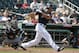 Cleveland Indians' Will Venable, right, hits a grounder as Chicago White Sox's Omar Narvaez, left, watches during the second inning of a spring training baseball game Monday, March 21, 2016, in Goodyear, Ariz. (AP Photo/Ross D. Franklin)