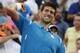 Novak Djokovic, of Serbia, celebrates after defeating Dominic Thiem, of Austria, 6-3, 6-4, at the Miami Open tennis tournament, Tuesday, March 29, 2016, in Key Biscayne, Fla. (AP Photo/Wilfredo Lee)
