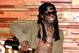AUSTIN, TX - MARCH 12: AUSTIN, TX - MARCH: Rapper Lil Wayne pours champagne over his Samsung Galaxy S7 at Samsung Galaxy Life Fest at SXSW 2016 on March 12, 2016 in Austin, Texas. (Photo by Jonathan Leibson/Getty Images for Samsung)