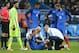 PARIS, FRANCE - MARCH 29: Injured, Jeremy Mathieu of France talks with medical staff of team France while goalkeeper Hugo Lloris (right), Raphael Varan and Andre-Pierre Gignac of France looks on during the international friendly match between France and Russia at Stade de France on March 29, 2016 in Saint-Denis near Paris, France. (Photo by Jean Catuffe/Getty Images)