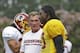 Washington Redskins quarterback Robert Griffin III, right, talks with head coach Mike Shanahan, during the NFL football teams training camp in Richmond, Va. Saturday, July 27, 2013. (AP Photo/Steve Helber)
