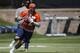 Denver Broncos rookie quarterback Paxton Lynch rolls out to pass during the team's NFL rookie camp football practice Friday, May 6, 2016, at the team's headquarters in Englewood, Colo. (AP Photo/David Zalubowski)