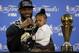 Cleveland Cavaliers' LeBron James answers questions as he holds his daughter Zhuri during a post-game press conference after Game 7 of basketball's NBA Finals Sunday, June 19, 2016, in Oakland, Calif. Cleveland won 93-89. (AP Photo/Eric Risberg)