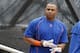 New York Mets center fielder Yoenis Cespedes removes his batting gloves before an interleague baseball game against the New York Yankees, Tuesday, Aug. 2, 2016, in New York. (AP Photo/Kathy Willens)