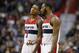 Washington Wizards guard Bradley Beal (3) and Washington Wizards guard John Wall (2) talk during a break in the first half of an NBA basketball game against the Charlotte Hornets, Monday, Feb. 2, 2015, in Washington. (AP Photo/Alex Brandon)