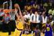 Larry Nance Jr. of Los Angeles Lakers scores as Kevin Durant and Draymond Green of the Golden State Warriors watch during their NBA game in Los Angeles, California on November 4, 2016. / AFP / Frederic J. BROWN (Photo credit should read FREDERIC J. BROWN/AFP/Getty Images)