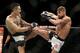 Max Holloway, left, fights Jeremy Stephens during a featherweight mixed martial arts bout at UFC 194, Saturday, Dec. 12, 2015, in Las Vegas. (AP Photo/John Locher)