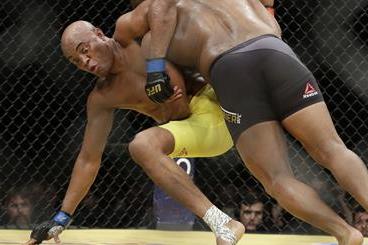 Daniel Cormier, right, takes down Anderson Silva during their light heavyweight mixed martial arts bout at UFC 200, Saturday, July 9, 2016, in Las Vegas. (AP Photo/John Locher)