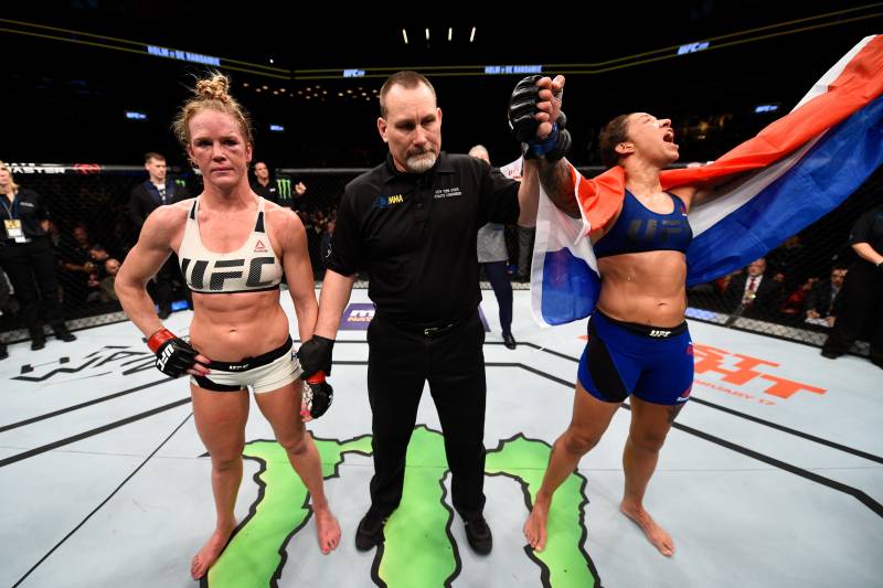 BROOKLYN, NEW YORK - FEBRUARY 11: (R-L) Germaine de Randamie of The Netherlands celebrates her victory over Holly Holm in their women's featherweight championship bout during the UFC 208 event inside Barclays Center on February 11, 2017 in Brooklyn, New York. (Photo by Jeff Bottari/Zuffa LLC/Zuffa LLC via Getty Images)