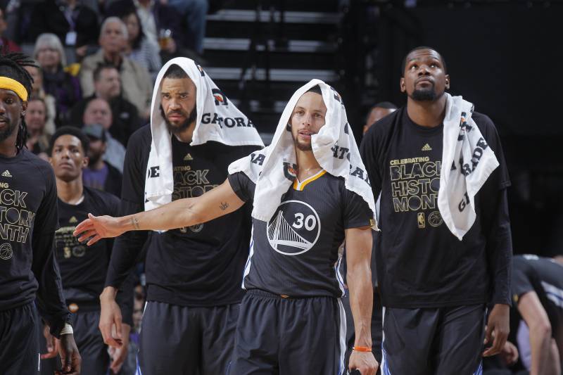 SACRAMENTO, CA - FEBRUARY 4: JaVale McGee #1, Stephen Curry #30 and Kevin Durant #35 of the Golden State Warriors cheer on their teammates against the Sacramento Kings on February 4, 2017 at Golden 1 Center in Sacramento, California. NOTE TO USER: User expressly acknowledges and agrees that, by downloading and or using this photograph, User is consenting to the terms and conditions of the Getty Images Agreement. Mandatory Copyright Notice: Copyright 2017 NBAE (Photo by Rocky Widner/NBAE via Getty Images)