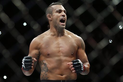 Vitor Belfort, from Brazil, celebrates after defeating Dan Henderson, from the United States, during their UFC middleweight mixed martial arts bout in Sao Paulo, Brazil, Sunday, Nov. 8, 2015. (AP Photo/Andre Penner)