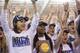 Arkansas' Sparkle McKnight, center, holds the trophy as her team