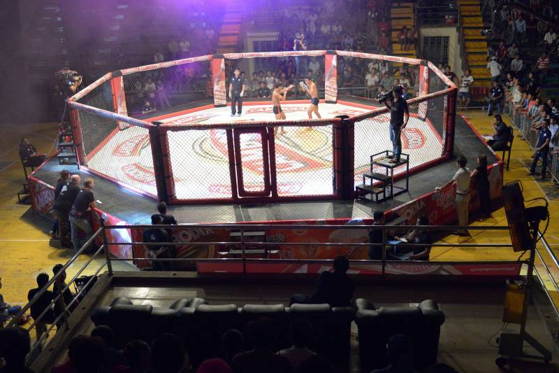 TO GO WITH AFP STORY: Cambodia-lifestyle-sport-MMA,FEATURE by Suy SE This photo taken on August 24, 2014 shows a general view of a Cambodian cage fight for a local television (TV) programme at a statium in Phnom Penh. He is schooled in ancient Cambodian martial arts, but Tok Sophon hopes to turn his pugilism skills into wealth and international glory in the modern cage-fighting arena -- a transition some fighters fear will wipe out their craft. AFP PHOTO/TANG CHHIN SOTHY (Photo credit should read TANG CHHIN SOTHY/AFP/Getty Images)