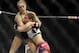 Ronda Rousey, left, of Venice, Calif., holds Miesha Tate of Yakima, Wash., during the UFC 168 mixed martial arts women's bantamweight title fight on Saturday, Dec. 28, 2013, in Las Vegas. Rousey won by a third round tap out. (AP Photo/David Becker)