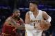 Los Angeles Lakers' D'Angelo Russell, right, is pressured by Cleveland Cavaliers' Kyrie Irving during the first half of an NBA basketball game Sunday, March 19, 2017, in Los Angeles. (AP Photo/Jae C. Hong)
