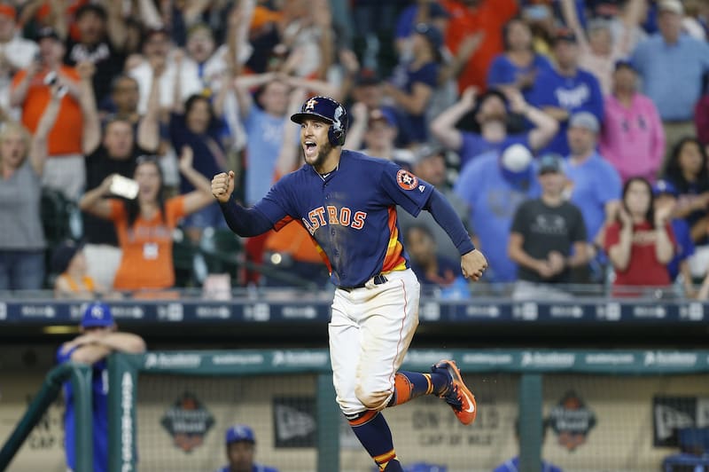 HOUSTON, TX - APRIL 09: George Springer #4 of the Houston Astros scores the winning run in the twelfth inning on an Evan Gattis #11 walk by Matt Strahm #64 of the Kansas City Royals at Minute Maid Park on April 9, 2017 in Houston, Texas. Houston won 5-4. (Photo by Bob Levey/Getty Images)