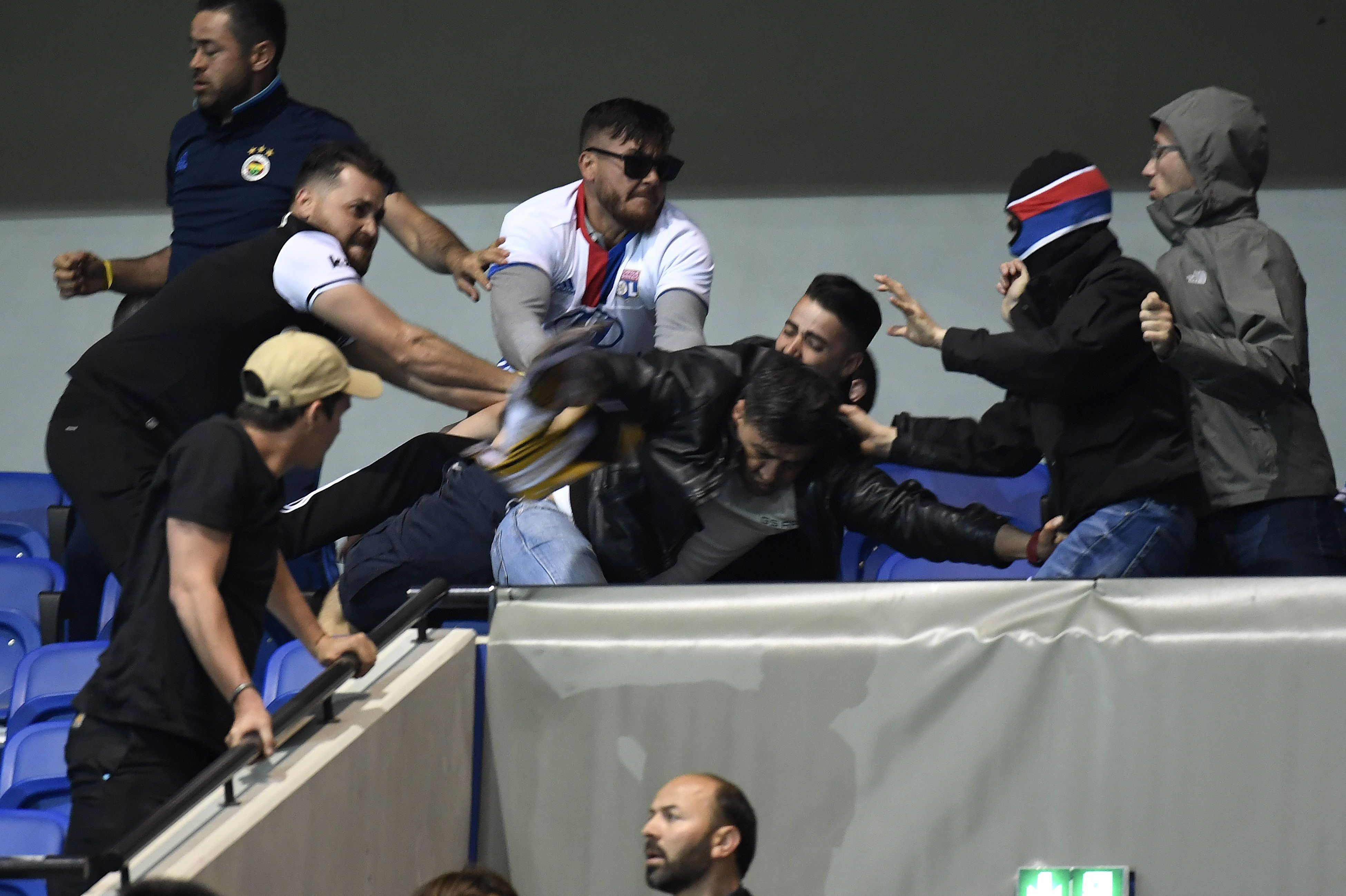 Besiktas' and Lyon's supporters fight before the UEFA Europa League first leg quarter final football match between Lyon (OL) and Besiktas on April 13, 2017, at the Parc Olympique Lyonnais stadium in Decines-Charpieu, central-eastern France. / AFP PHOTO / PHILIPPE DESMAZES (Photo credit should read PHILIPPE DESMAZES/AFP/Getty Images)