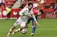 Real Madrid's Isco, left, duels for the ball with Sporting de Gijon's Sergio Alvarez during the Spanish La Liga soccer match between Real Madrid and Sporting de Gijon, at El Molinon stadium in Gijon, northern Spain, Saturday, April 15, 2017. (AP Photo/Alvaro Barrientos)