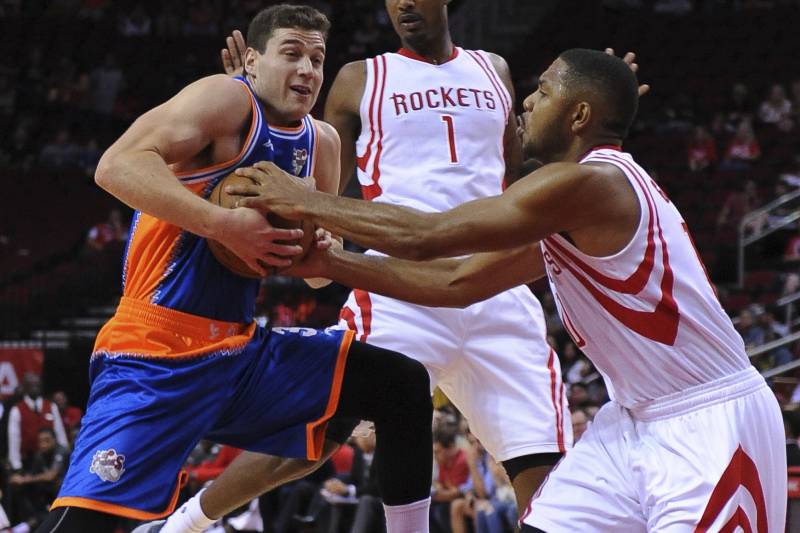 The Shanghai Sharks Jimmer Fredette, left, is defended by the Houston Rockets Eric Gordon (10) in the first half of an NBA basketball exhibition game Sunday, Oct. 2, 2016, in Houston. (AP Photo/George Bridges)