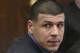 Former New England Patriots tight end Aaron Hernandez looks back during his trial at Suffolk Superior Court on Tuesday, March 28, 2017, in Boston. Hernandez is standing trial for the July 2012 killings of Daniel de Abreu and Safiro Furtado who he encountered in a Boston nightclub. Hernandez is already serving a life sentence in the 2013 killing of semi-professional football player Odin Lloyd. (Nancy Lane/The Boston Herald via AP, Pool)