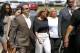 Racquel Smith, center, widow of former New Orleans Saints star Will Smith, arrives at the Orleans Parish criminal courthouse, Thursday, April 20, 2017, in New Orleans, with supporters, for the second day of a sentencing hearing for Cardell Hayes, who killed her husband and shot her, and was convicted of manslaughter. (AP Photo/Gerald Herbert)