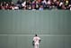 Baltimore Orioles' Adam Jones looks up at fans in center field during the third inning of a baseball game against the Boston Red Sox, Tuesday, May 2, 2017, in Boston. (AP Photo/Michael Dwyer)