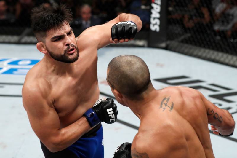 FORTALEZA, BRAZIL - MARCH 11: (L-R) Kelvin Gastelum punches Vitor Belfort of Brazil in their middleweight bout during the UFC Fight Night event at CFO - Centro de Forma%26#x8D;co Olimpica on March 11, 2017 in Fortaleza, Brazil. (Photo by Buda Mendes/Zuffa LLC/Zuffa LLC via Getty Images)