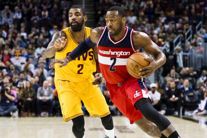 CLEVELAND, OH - MARCH 25: John Wall #2 of the Washington Wizards drives past Kyrie Irving #2 of the Cleveland Cavaliers during the first half at Quicken Loans Arena on March 25, 2017 in Cleveland, Ohio. NOTE TO USER: User expressly acknowledges and agrees that, by downloading and/or using this photograph, user is consenting to the terms and conditions of the Getty Images License Agreement. (Photo by Jason Miller/Getty Images)