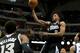 Sacramento Kings' Derrick Williams (13) and Dallas Mavericks' Devin Harris, right, watch as the Kings' Rudy Gay (8) breaks to the basket for a shot in the first half of an NBA basketball game, Saturday, March 29, 2014, in Dallas. (AP Photo/Tony Gutierrez)