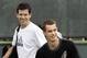 Unseeded Tim Henman, left, of Great Britain passes behind his countryman, 13th-seed Andy Murray on a practice court at the Pacific Life Open tennis tournament in Indian Wells, Calif. Wednesday, March 7, 2007. (AP Photo/Elise Amendola)