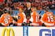 Members of the Philadelphia Flyers Alumni team, from the left, Bill Barber, Eric Lindros, Bob Clarke and coach Pat Quinn (standing) on the bench during the Winter Classic Alumni hockey game with the New York Rangers Alumni team, Saturday, Dec. 31, 2011 in