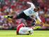 Etienne Capoue leaps over an Arsenal player during the North London derby.