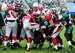 Ellington (center) gets bottled up.