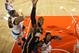 Roy Hibbert is hemmed in by the New York Knicks' Kenyon Martin (L) and Iman Shumpert.
