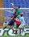 Mattia Perin (in green) claims a cross during Genoa's November tilt with Lazio.