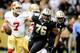 Saints defensive end Akiem Hicks bears down on 49ers quarterback Colin Kaepernick.
