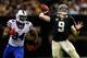 Mario Williams looks on as Brees fires downfield.