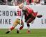 49ers Donte Whitner forces the ball away from Buccaneers running back Brian Leonard with a big hit.