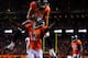 Eric Decker celebrates a touchdown with Andre Caldwell while Demaryius Thomas looks on.