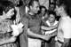 Fangio (middle) congratulates Stirling Moss after Moss' victory at the 1957 Italian Grand Prix.