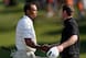 Brendan Grace shakes hands with Tiger Woods.